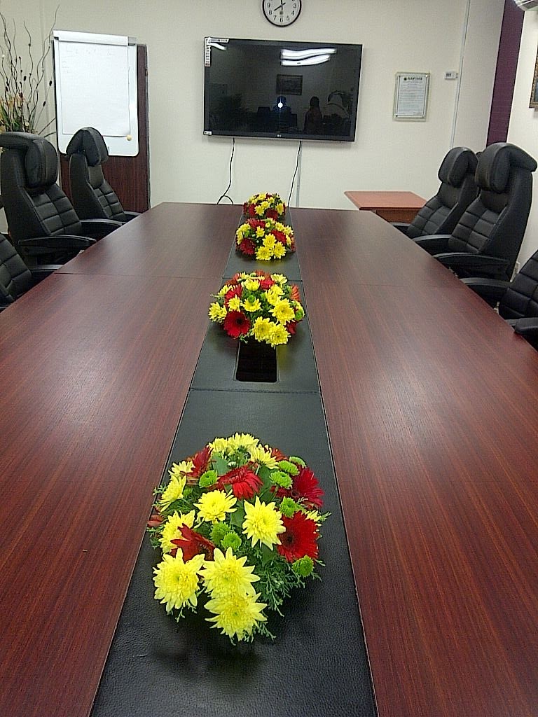A Room with five set of flower arrangement on the table