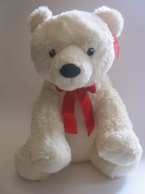 Large white teddy bear with red bow
