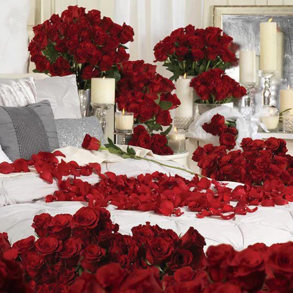 bedroom decorated with roses,rose petals and candles.