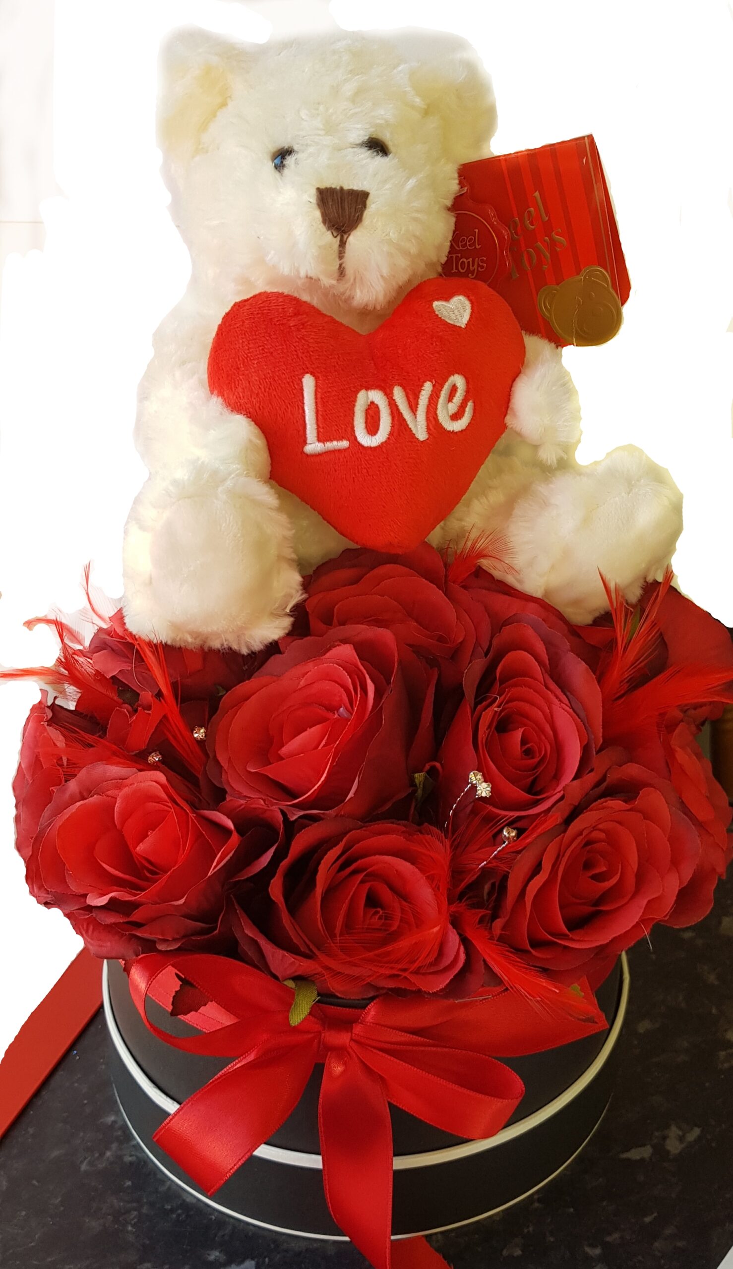 Black flower box with Teddy sitting at the top.