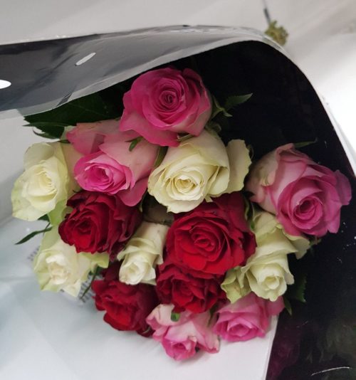 white,pink and red roses hand tied and wrapped in cellophane