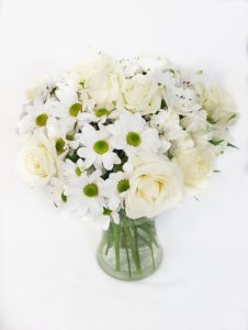 Mixed white flowers arrangement with a variety of white flowers