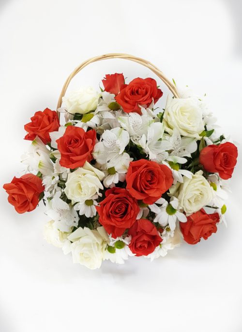 Red and white roses arranged in a basket