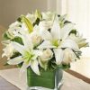 roses and lilies arranged in square flower vase