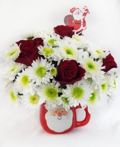 Christmas Flowers arrangement in a Santa Mug