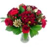 A Christmas flower bouquet with mixed red flowers, greenery and gold pinecones.