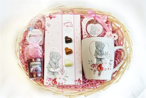 Gift basket with a box of chocolates, candle and mug