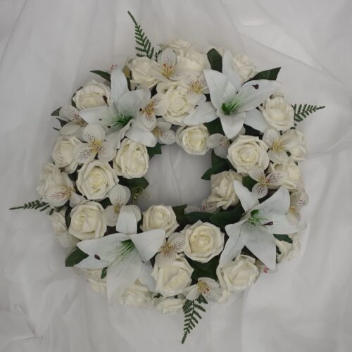 White artificial funeral wreath with roses and lilies