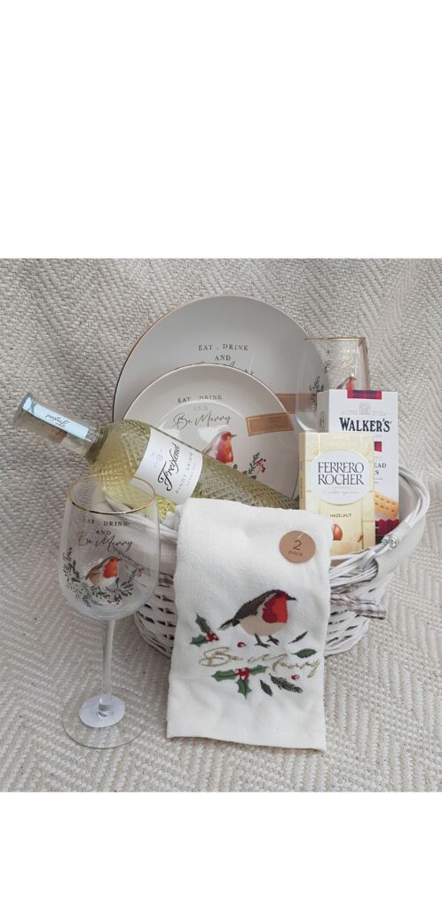 A Christmas hamper gift basket with dinner set and festive gifts in Nigeria